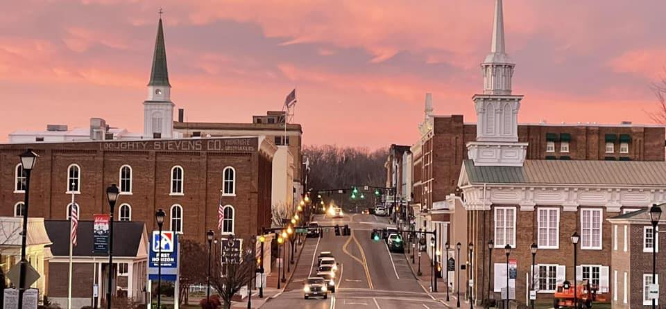 Greeneville, TN drone photography looking over downtown Greeneville with Blue Ridge Mountains in the distance